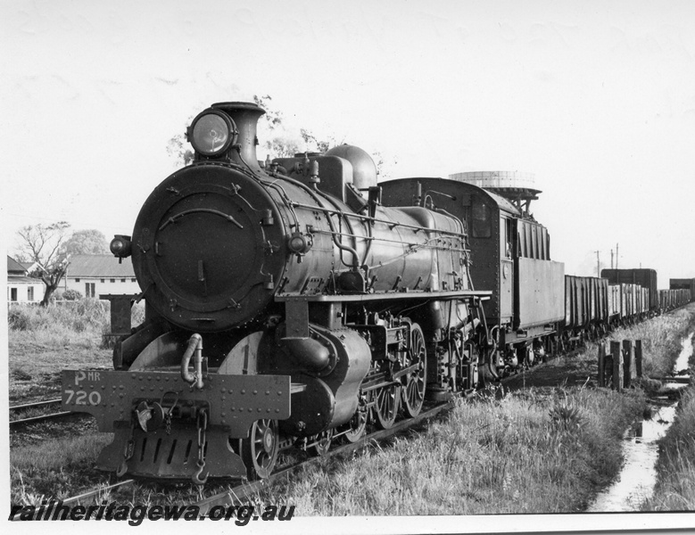 P17767
PMR class 720 at Yarloop with 21 Goods. SWR line. Portion of water tower visible above tender of locomotive. Front and side view of locomotive.

