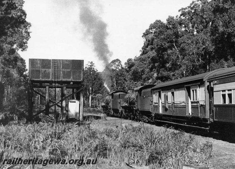 P18103
W class 908 & 927 steam locomotives at the head of a RESO train at Cambray. BN line. Water tower at left with pump house beneath.
