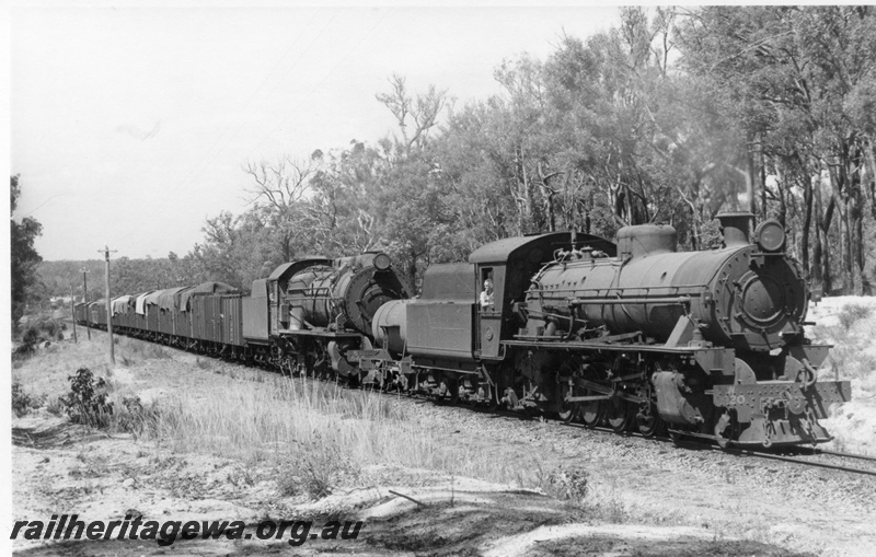 P18108
W class 920 and an unidentified S class steam locomotives at the head of a goods train at an Unknown location. Front and side view of leading locomotive.
