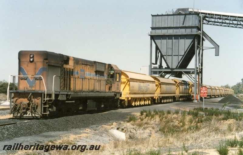 P18150
NA class 1874, on train loading coal at Griffin loading facility comprising tower and conveyor, Chicken Creek, front and side view
