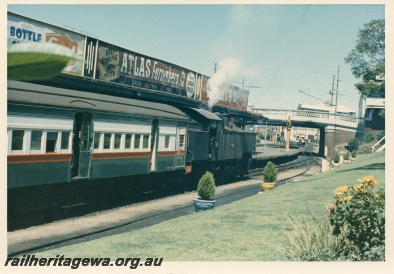 P18154
DD class locomotive, on passenger train to Armadale, advertising hoardings, trolley bus on Barrack Street bridge, landscaped garden, Perth station, SWR line
