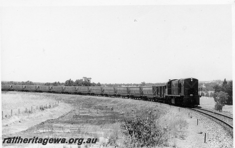P18261
R class 1904, on bauxite train, long hood leading, in rural setting, side and front view
