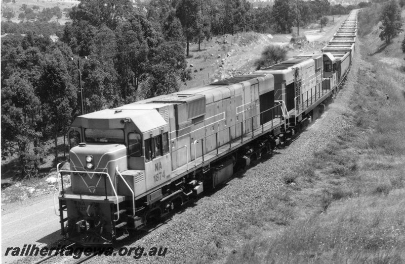 P18265
NA class 1874, double heading with another NA class diesel, on bauxite train, in rural setting, front and side view, c1966
