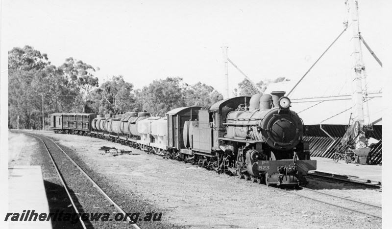 P18282
1 of 4 images of PR class 523 on goods train including JGS class 5022 tank wagon for furnace oil, at station, side and front view
