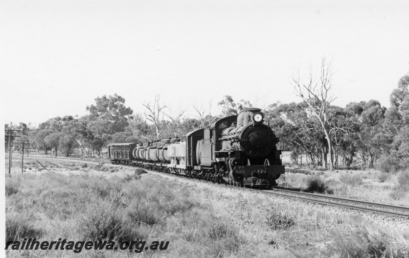 P18283
2 of 4 images of PR class 523 on goods train including JGS class 5022 tank wagon for furnace oil, in rural setting, side and front view
