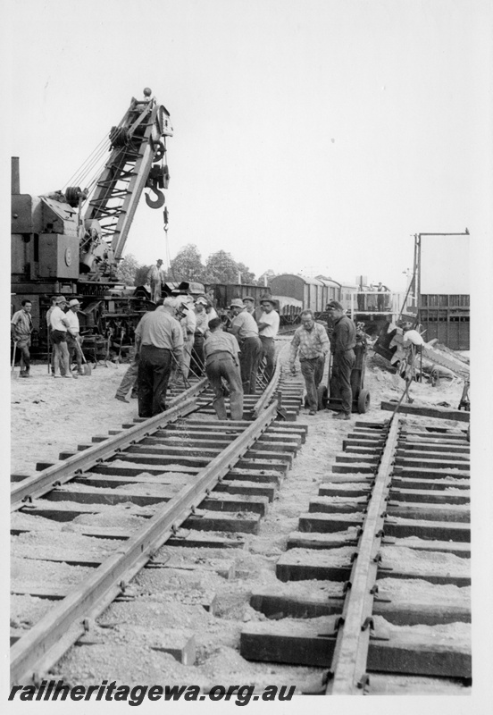 P18326
Track laying team, crane, goods wagons, demolition of West Midland station, ER line 
