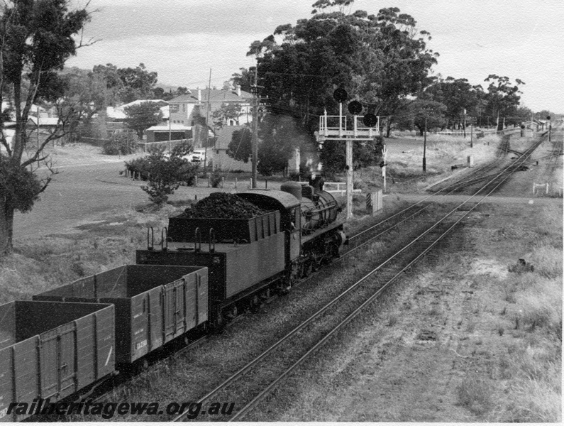 P18329
PMR class 723 on 1:55pm Perth to Bunbury goods train, approaching station, bracket signal, level crossing, station building and platform, Armadale, SWR line 
