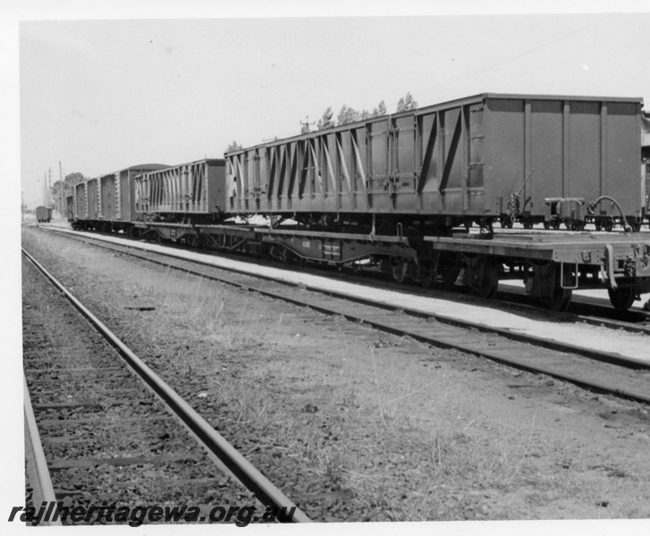 P18361
1 of 4 images of Commonwealth Railways (CR) wagons at Bassendean, including two GL class wagons on flat bed trucks and two VE class wagons, side and end view
