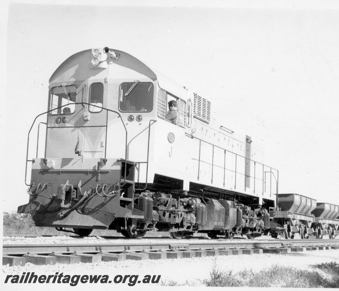 P18386
1 of 5 images of J class 101 on standard gauge ballast train comprising ex-Commonwealth Railways (CR) WSJ class hoppers near Kenwick, end and side view of loco and three hoppers
