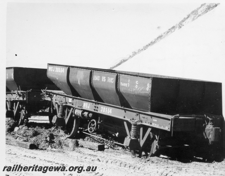 P18387
2 of 5 images of J class 101 on standard gauge ballast train comprising ex-Commonwealth Railways (CR) WSJ class hoppers near Kenwick, WSJ class 30554, end and side view
