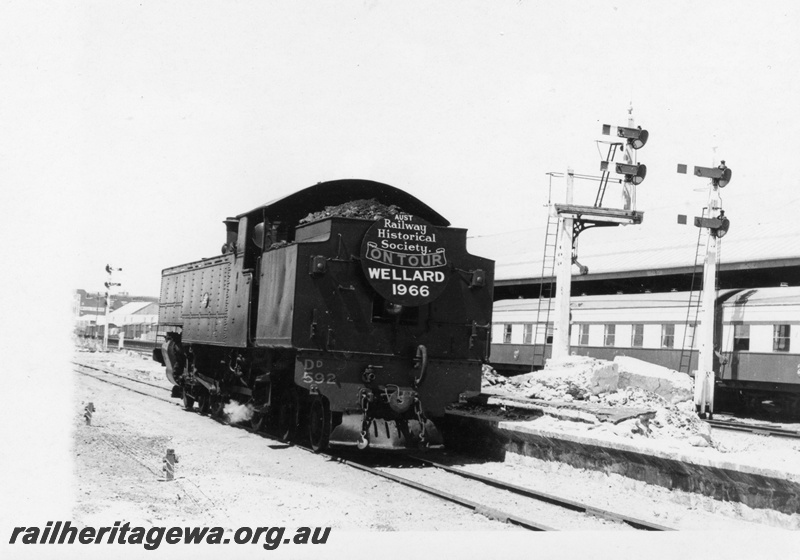 P18406
3 of 5 images of DD class 592 on ARHS tour train to Wellard, loco off train, tender first to camera, carriages at adjacent platform, bracket signals

