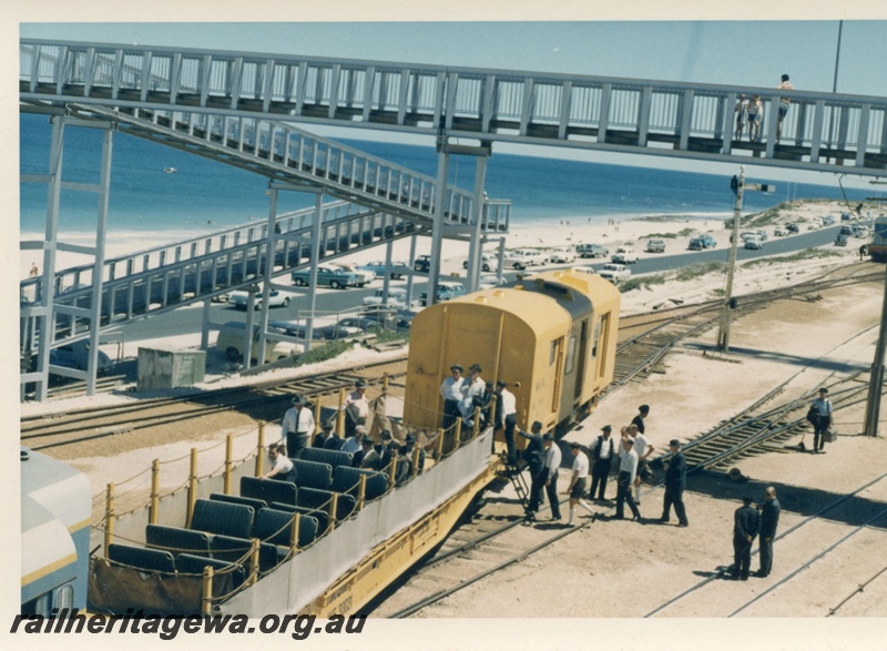 P18413
Standard gauge inspection train, including yellow van and WF class 3003 flat wagon with seats installed, passengers boarding by ladder, overhead footbridge, signal, beach, Leighton yard
