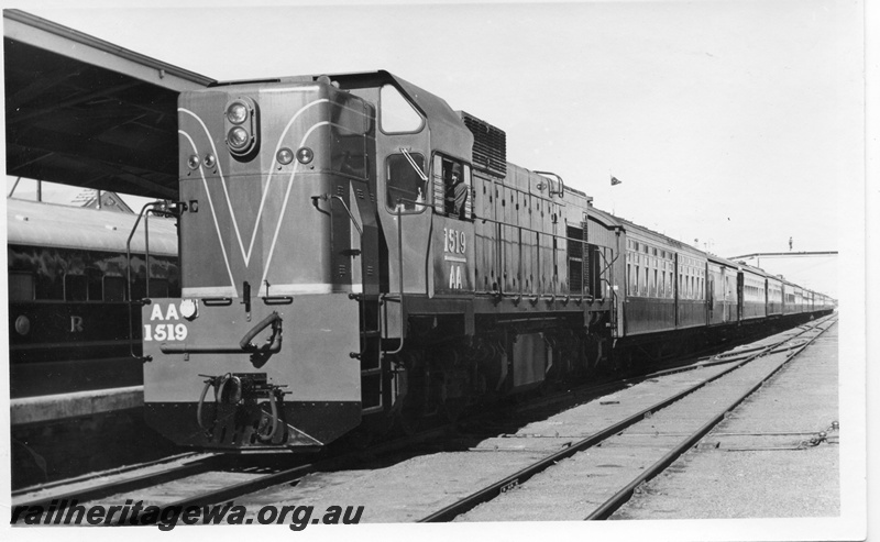 P18472
3 of 12 images relating to the ceremony for the linking of the standard gauge railways at Kalgoorlie, AA class 1519, on special 19 car train which brought Perth guests to the ceremony, front and side view. Train comprised AZS class 445, Z class 9, AV class 425, AV class 286, AVL class 314, AYL class 29, AQZ class 423, AGZ class 416, AZ class 443, AZ class 440, AZ class 437, AGS class 22, AH class 563, AH class 562, AH class 560, AL class 4, AM class 313, AM class 414, ZJA class 431
