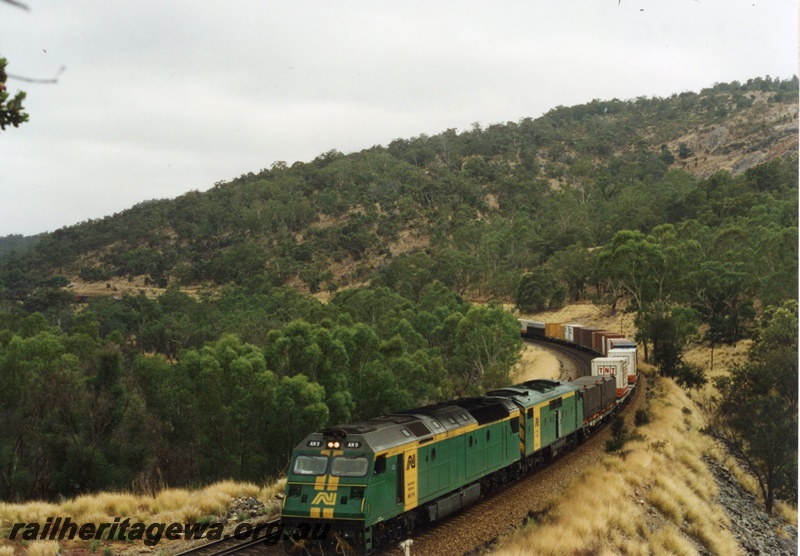 P18634
AN class 9 and GM class 38 standard gauge diesel locomotives on a Forrestfield bound freight train from Sydney travelling through the Avon Valley. Both locomotives were owned by Australian National Railways and painted in the green and gold colour scheme.
