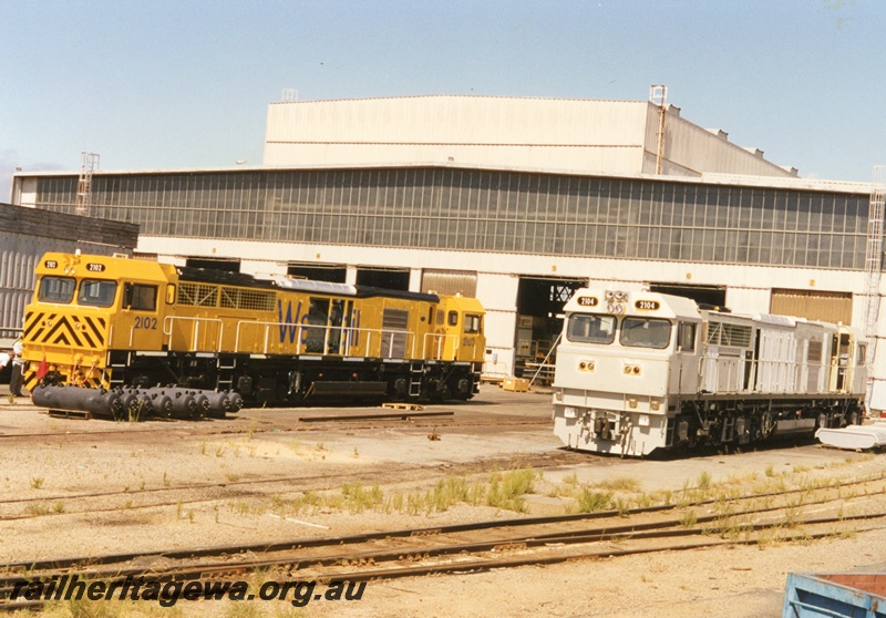 P18667
Clyde EMD Works at Forrestfield with 2 new S class 2102 and 2104 locomotives under construction. 2102 has been painted in Westrail yellow while 2104 is still in its primer scheme.
