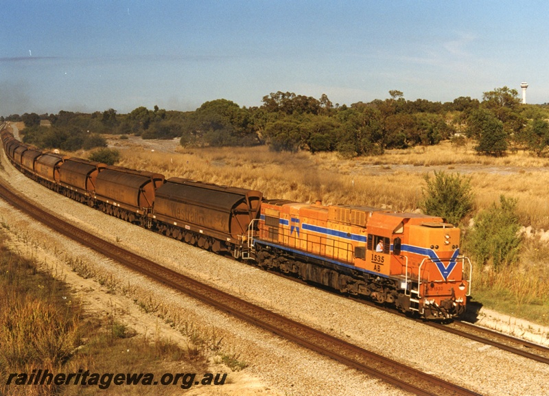 P18673
AB Class 1535 diesel locomotive hauling a train with mineral sands XY Class hoppers backloaded with coal to Chandala, Hazelmere
