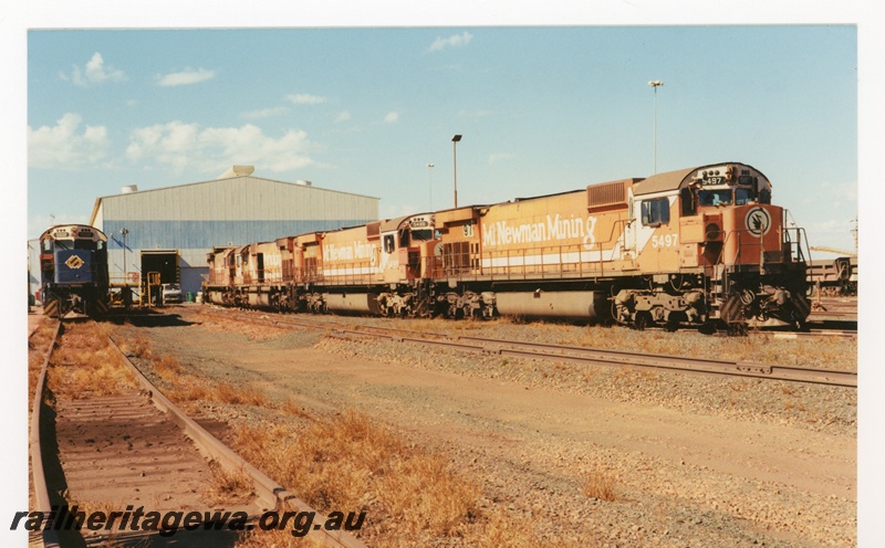 P18786
BHP Iron Ore (BHPIO) M636 Class 5502, (left- blue livery), 5497, 5499, 5496 (right - orange livery) at Port Hedland 
