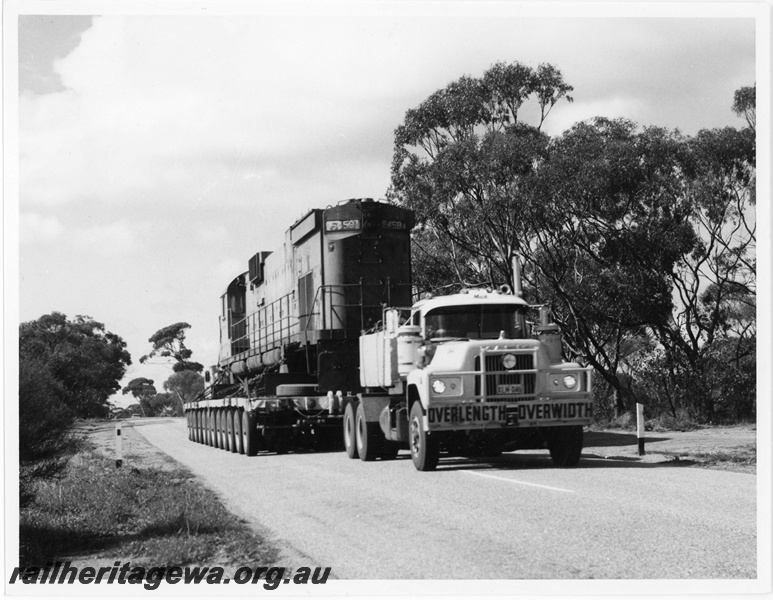 P18917
Mount Newman (MNM) C636 class 5458 on road low loader travelling on Great Northern Hwy near Miling enroute to Perth for rebuilding. 
