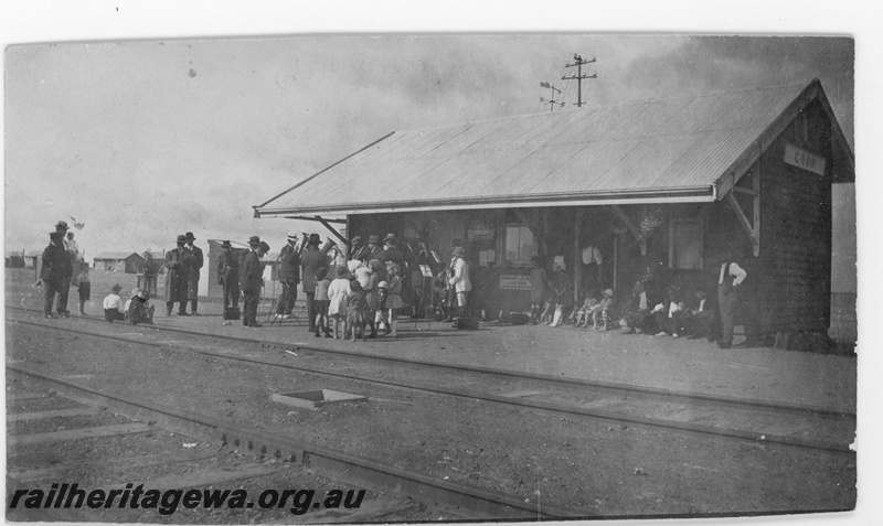 P19162
Commonwealth Railways (CR) station building, crowd outside including Mr Liston, tracks, Cook, TAR line, trackside view
