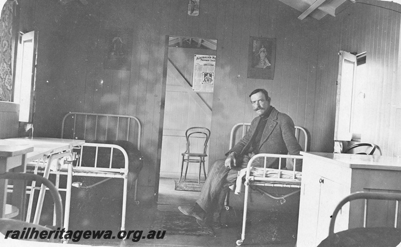 P19165
Interior view of four bed ward in hospital car, man seated on bed, Commonwealth Railways (CR) 