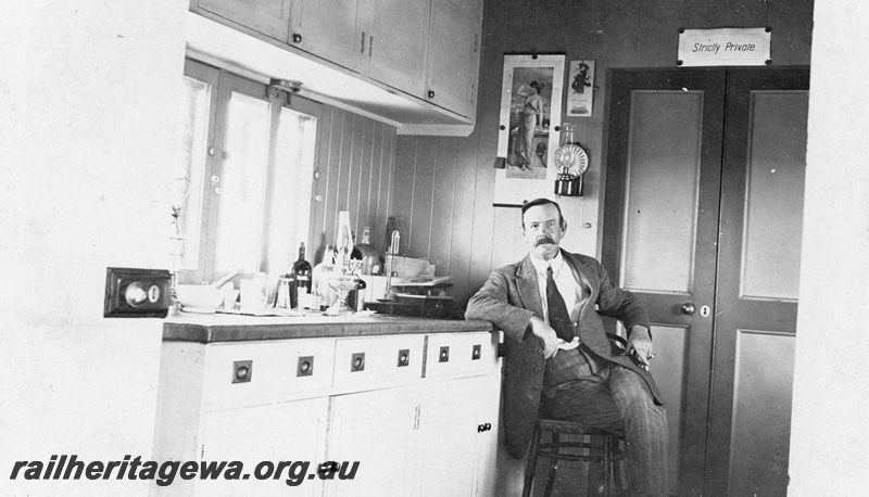 P19166
Interior view of dispensary in hospital car, man seated on chair, Commonwealth Railways (CR) 