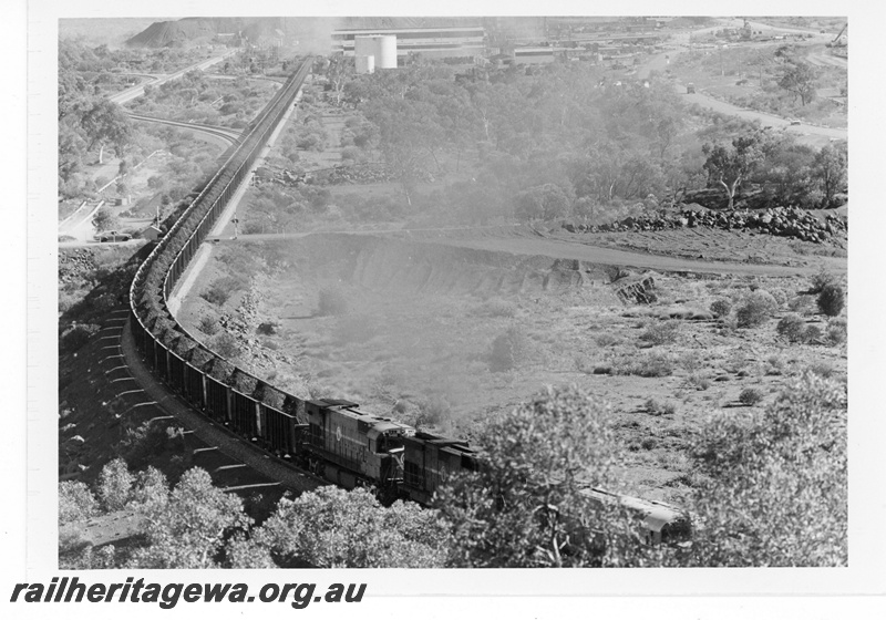 P19220
Mount Newman Mining (MNM) Locotrol train - 270 cars departs Newman mine site.
