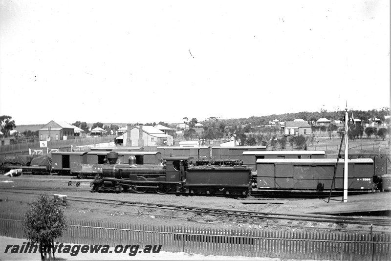 P19295
R class 231, on train to Southern Cross, assortment of pre 1900 vans with post 1900 wagon classifications, signal, platform ramp, town buildings, picket fence, east end of Northam station, EGR line, c1902-1905
