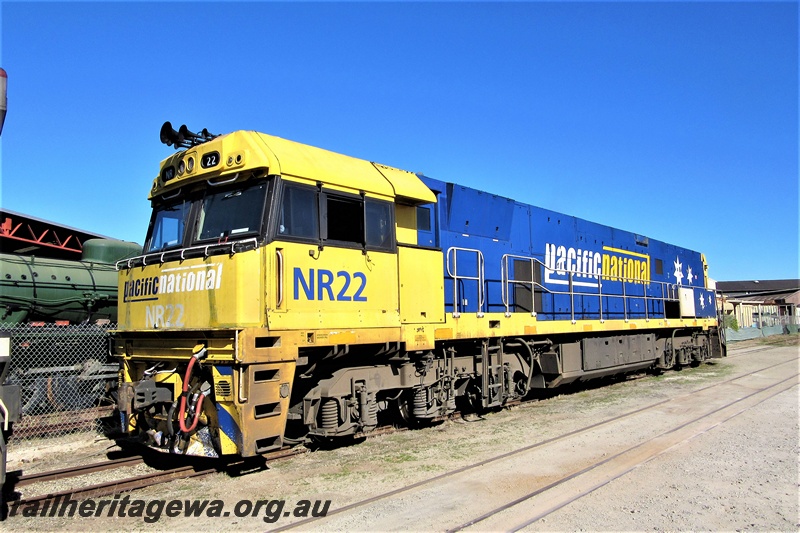 P19314
Pacific National NR class 22, yellow and blue livery, awaiting its next move, parked on the storage line on the site of the Rail Transport Museum, front and side view
