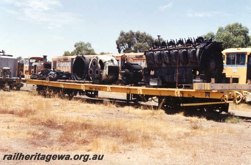 P19478
QMF class 16155 flat wagon, yellow livery, locomotive diesel engine tied down to the deck, Midland Workshops, side and end view
