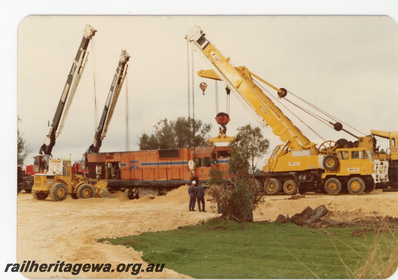 P19621
N class 1880 being lifted by 3 cranes following a level crossing accident with a truck at Wagerup. SWR line.
