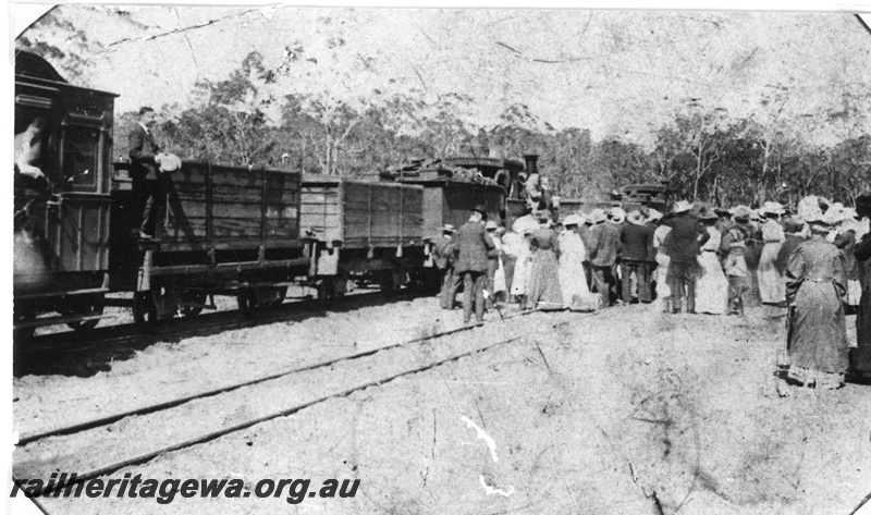 P19652
G class 114, large crowd for the opening of the Jarrahwood-Nannup Railway, WN line, opened by the Colonial Treasurer, Frank Wilson and Sir John Forrest. A special train took guests to Nannup even though public trains had been operating since 26th March 1909. Behind the loco are two tank wagons with wooden tanks followed by AM class 261 Ministerial carriage. (see also P07966)
