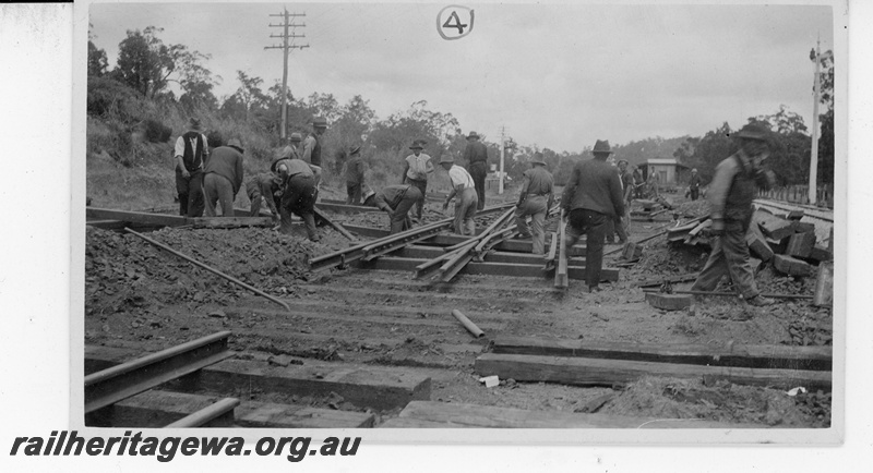 P19655
3 of 5 images of the installation of a double compound (double slip) at Parkerville, ER line. Images 1 & 2 in the sequence are numbered P01052 & P01053. This image, taken at 11am, shows the pointwork in position ready to lower onto the formation
