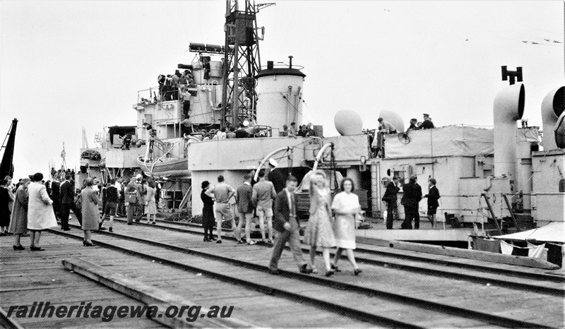 P19698
HMAS Yarra II which docked for a three day visit to Busselton on the 26,11 1937. The ship was open for public inspection hence the crowd on the jetty, view along the jetty.
