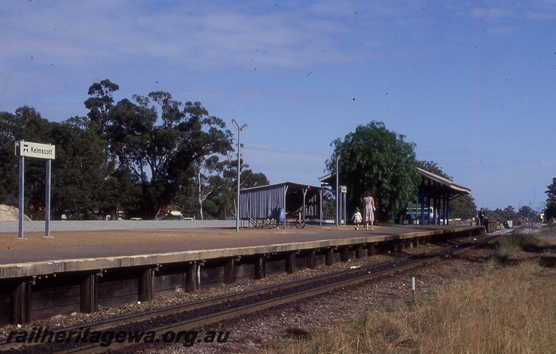 P19786
Platform, shelters, bicycle rack, mother and child, station nameboards, track, Kelmscott, SWR line
