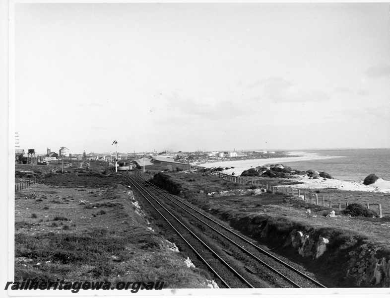 P20085
View of Leighton, looking towards Fremantle, tracks, signals, water tank, industrial buildings, oil tanks, beach, ocean 

