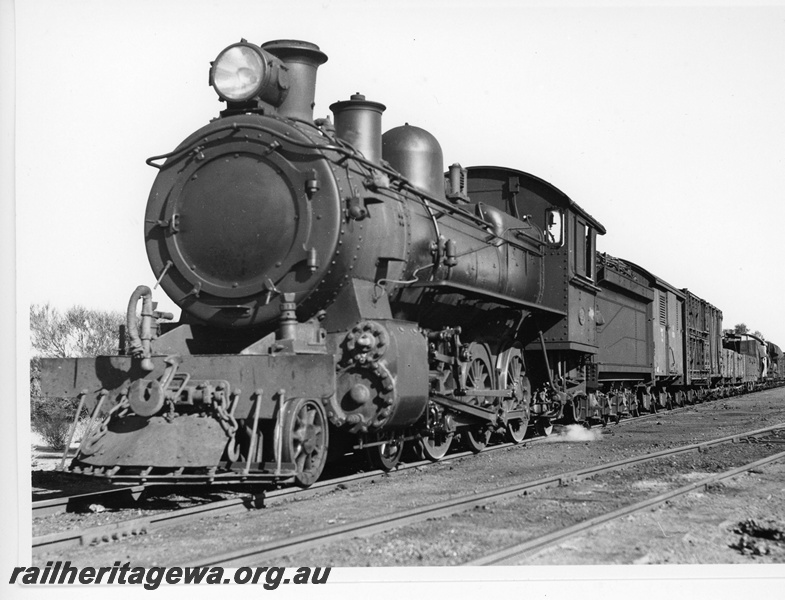 P20115
E class loco, on goods train of vans and wagons, Karalee, EGR line, front and side view
