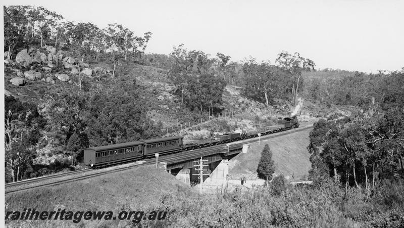 P20189
E class hauls a mixed train over the Jane Brook bridge National Park. Rear view of train two AD class carriages on train. ER line.
