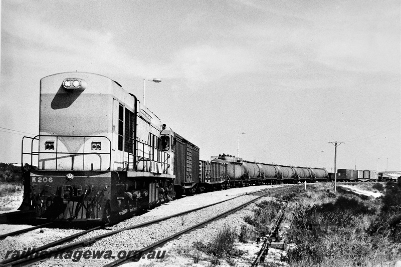 P20356
K class 206 in standard gauge livery on freight train which includes five high capacity fuel tank wagons, points, siding, departing Esperance for Kalgoorlie, CE line, front and side view  
