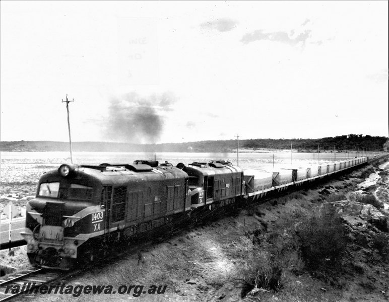 P20721
XA class 1403 &  XA class 1406 (both locomotives fitted with air brakes)  approach Norseman XNG class wagons loaded with  salt  from Lake Lefroy bound for Esperance. CE line. 
