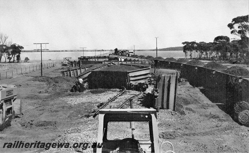 P20729
Standard Gauge loaded iron ore train derailment near Southern Cross. Photo depicts numerous WO class wagons rolled over and  L class locomotives in background. EGR line. 
