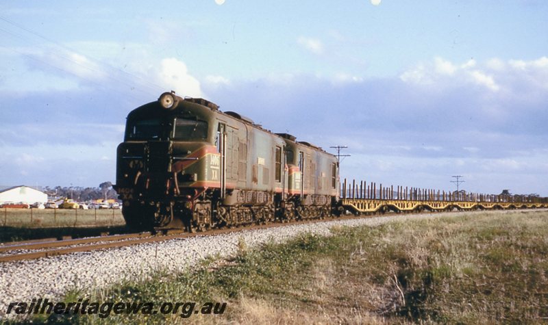 P20759
XA class 1406 & XA class 1409 (both locomotives green with red/yellow stripes)haul a rail recovery train near Merredin. EGR line.
