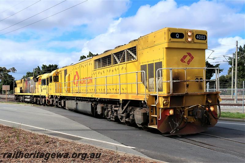 P21015
Aurizon Q class 4003 in the plain yellow  with a red logo livery towing ACC class 6030 across Railway Parade, Bassendean en route to UGL's plant for repairs, side and end view.
