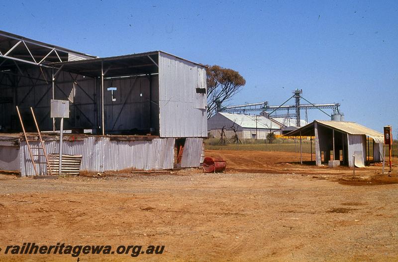 P21056
1 of 2 views of the closed and abandoned Shell fuel depot at Goomalling, view into the yard showing the abandoned structures, note the fire extinguisher in the red box mounted on a pole 
