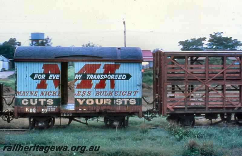 P21065
DE class 59, four wheel van with an advertisement for Mayne Nickless painted on the side, note the door partially opened, coupled to CXA class 11401 four wheel sheep wagon, side view
