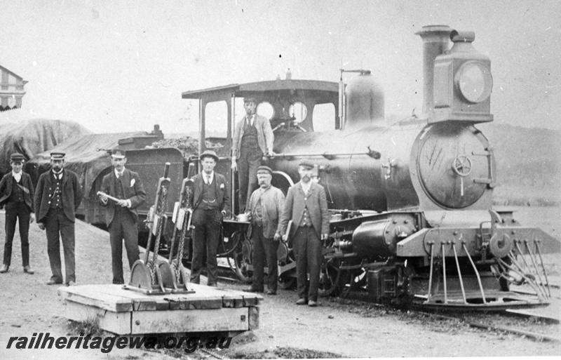 P21076
A class loco, on goods train, platform, striped canopy edge, station master J H Byrne with staff and crew, Spencers Brook, ER line, side and front view. See P21075
