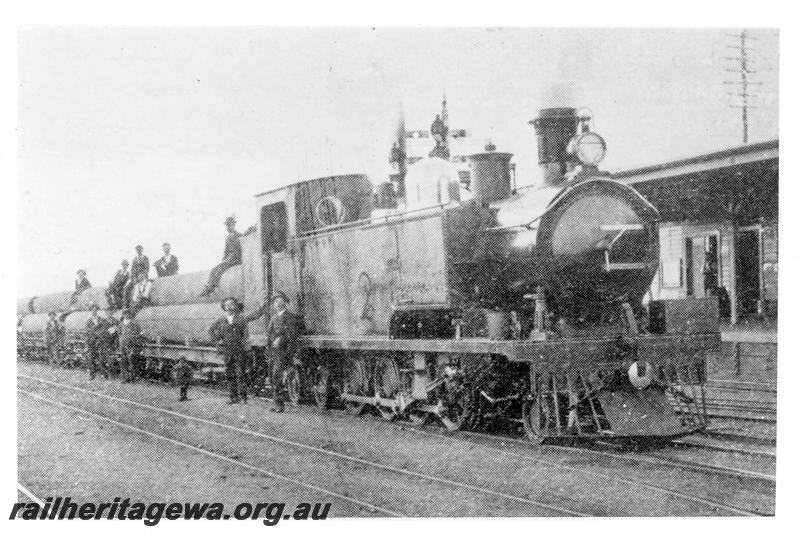 P21080
K class 112 (later renumbered 191) on goods train loaded with first batch of locally made pipes for Goldfields Water Supply System, onlookers, Welshpool, SWR line, side and front view

