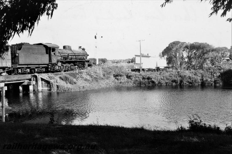 P21094
W class loco hauling goods train over Vasse River bridge, signal, river, river bank, shed, WN line, rear and side view
