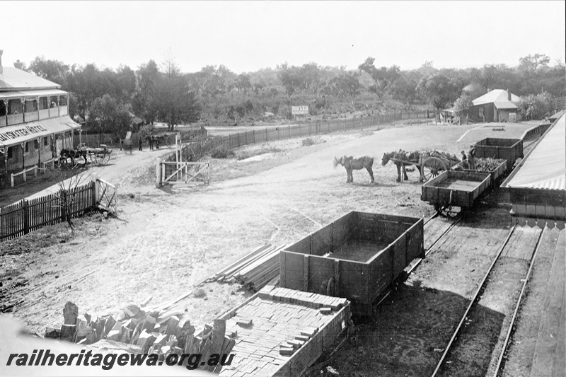 P21201
Station yard with a loading platform, wagons in the loop, one loaded with bricks, horse and dray, Bayswater , elevated view along the yard
