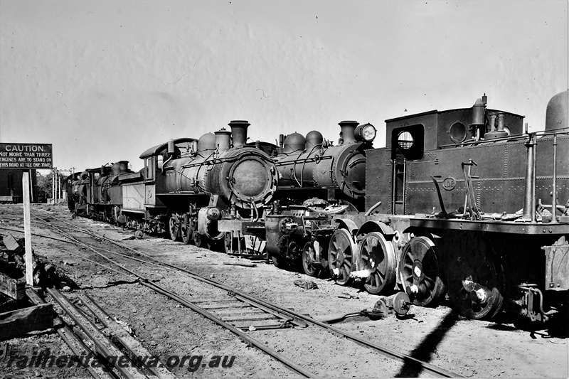 P21255
K class 102, several other steam locomotives, awaiting repairs or scrapping, workshop buildings, points, sidings, Midland, ER line, side and front view, c1946
