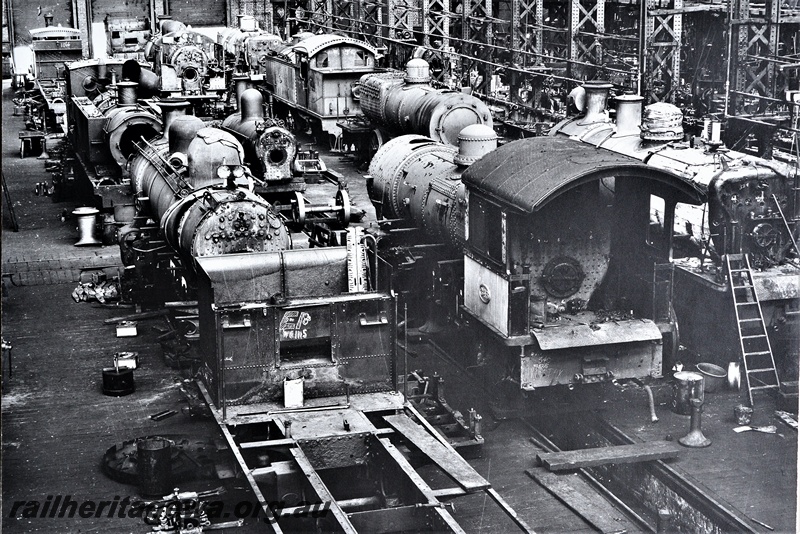 P21257
Fitting Shop, Block 3, Midland Workshops, overview from an elevated position of multiple locomotives under overhaul or repair
